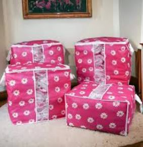 Collapsible large-capacity wardrobe organizer bag with floral pattern for bedsheet and comforter storage.