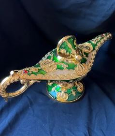 Close-up of the embossed metalwork on an antique style wishing lamp.