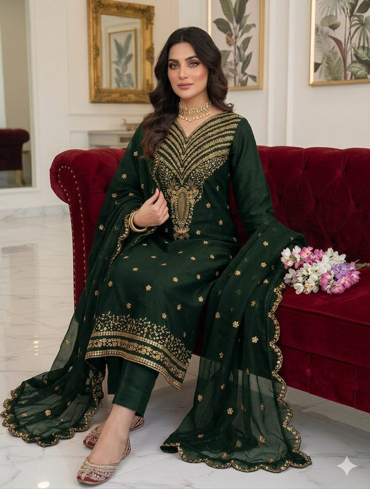 Emerald green unstitched ladies suit with heavy embroidered daman and chiffon dupatta