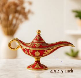 A decorative miniature 4x2.5 inch vintage Aladdin lamp with red enamel and gilded gold engravings, on a marble table.