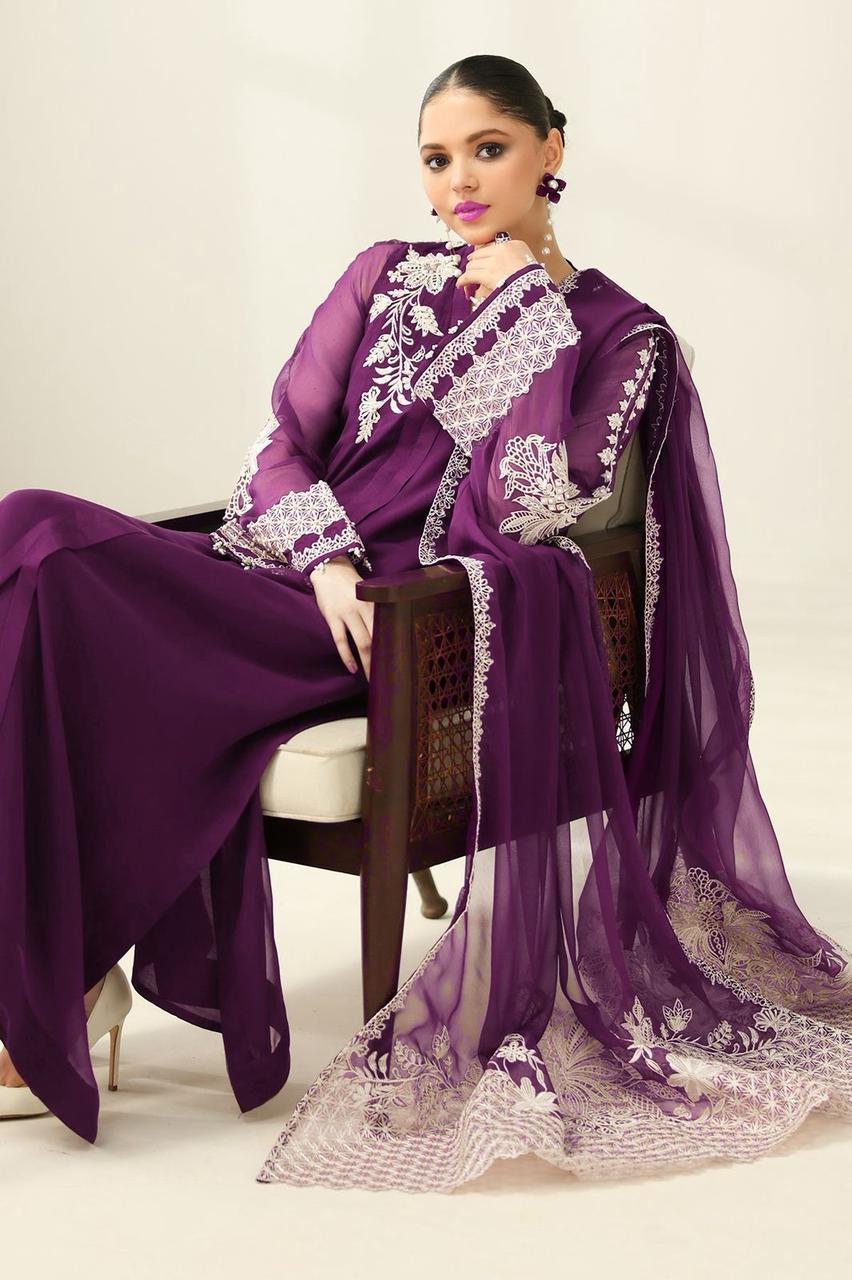 Model sitting in a purple embroidered chiffon 3-piece unstitched suit with white lace details.