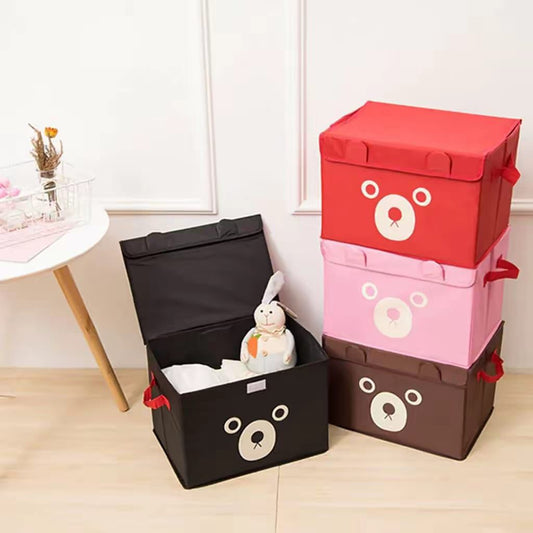 Stack of colorful foldable bear-themed storage boxes in brown, black, red, pink, and blue for nursery toy organization.